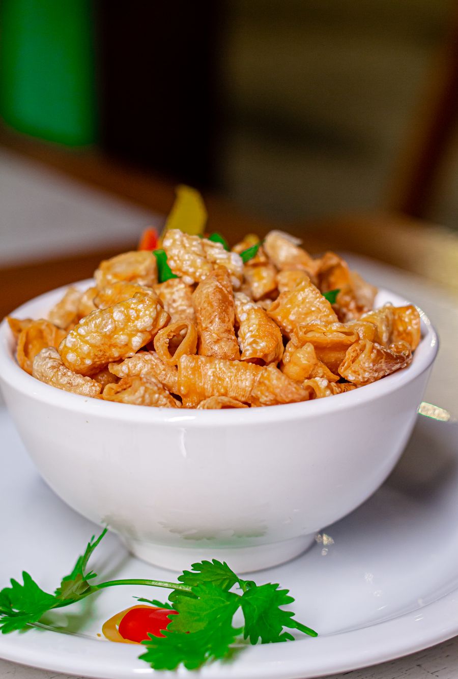 Pork rinds with herbs in a white bowl